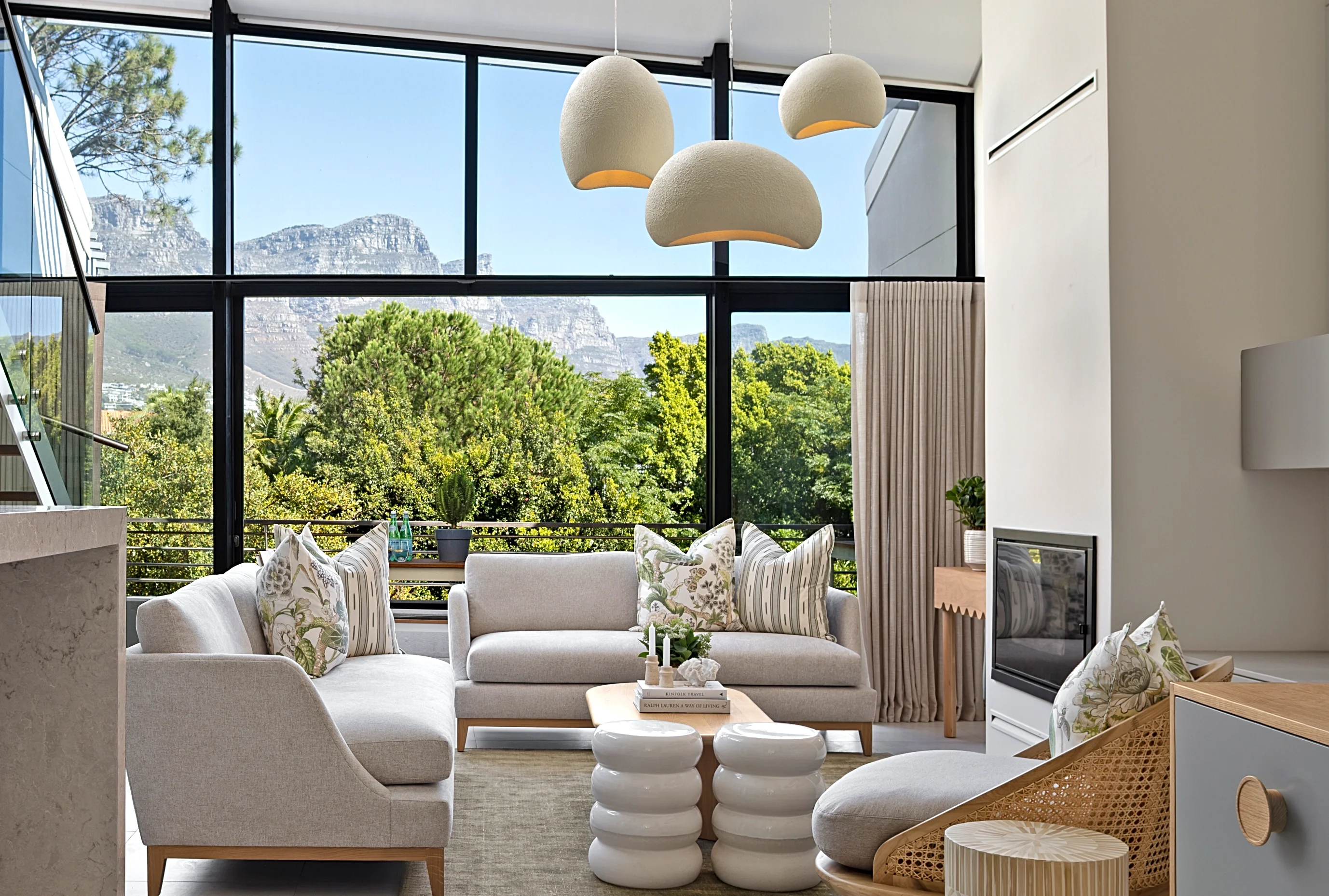 Living room at The Glen, Camps Bay, with pendant lights and the mountain view