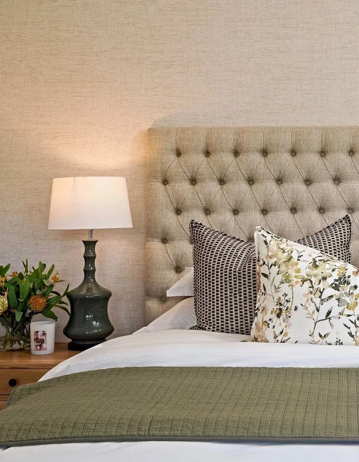 Main bedroom at Loxley Estate: oatmeal buttoned headboard, botanical cushions