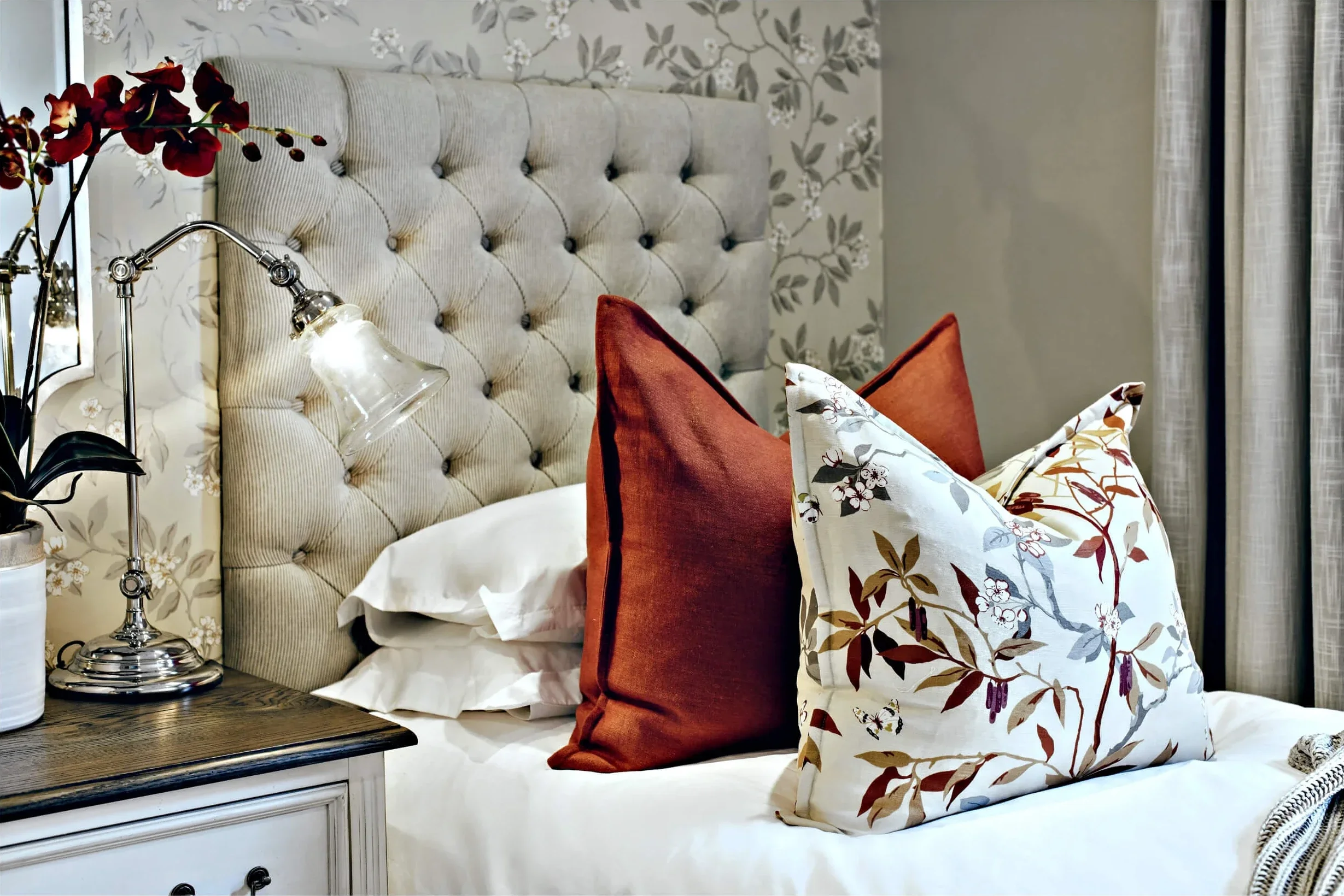 Twin bedroom in Johannesburg, detail of the rust and botanical cushions