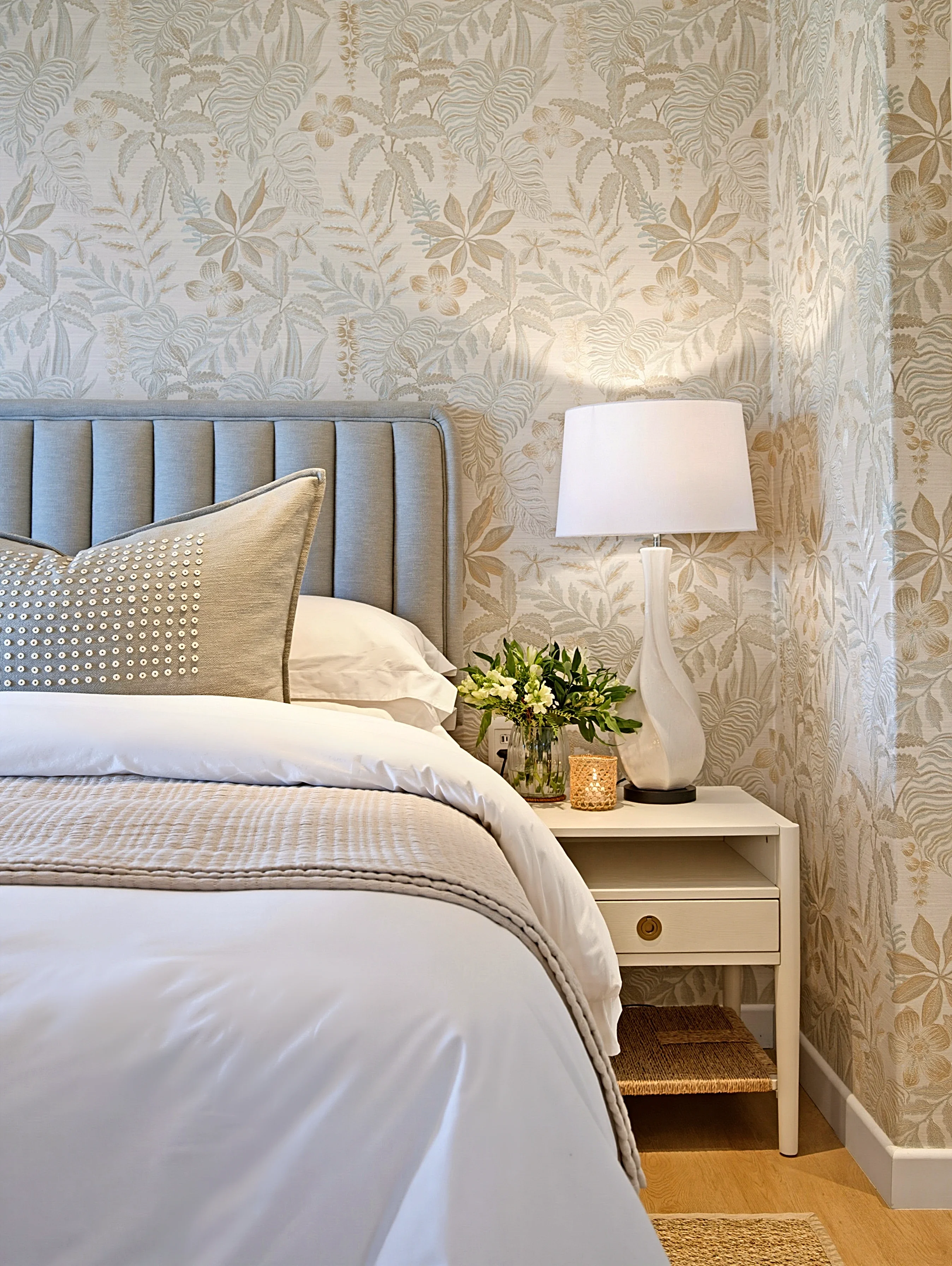 Master bedroom at Simbithi Eco-Estate: the bedside table, ceramic lamp and botanical wallpaper