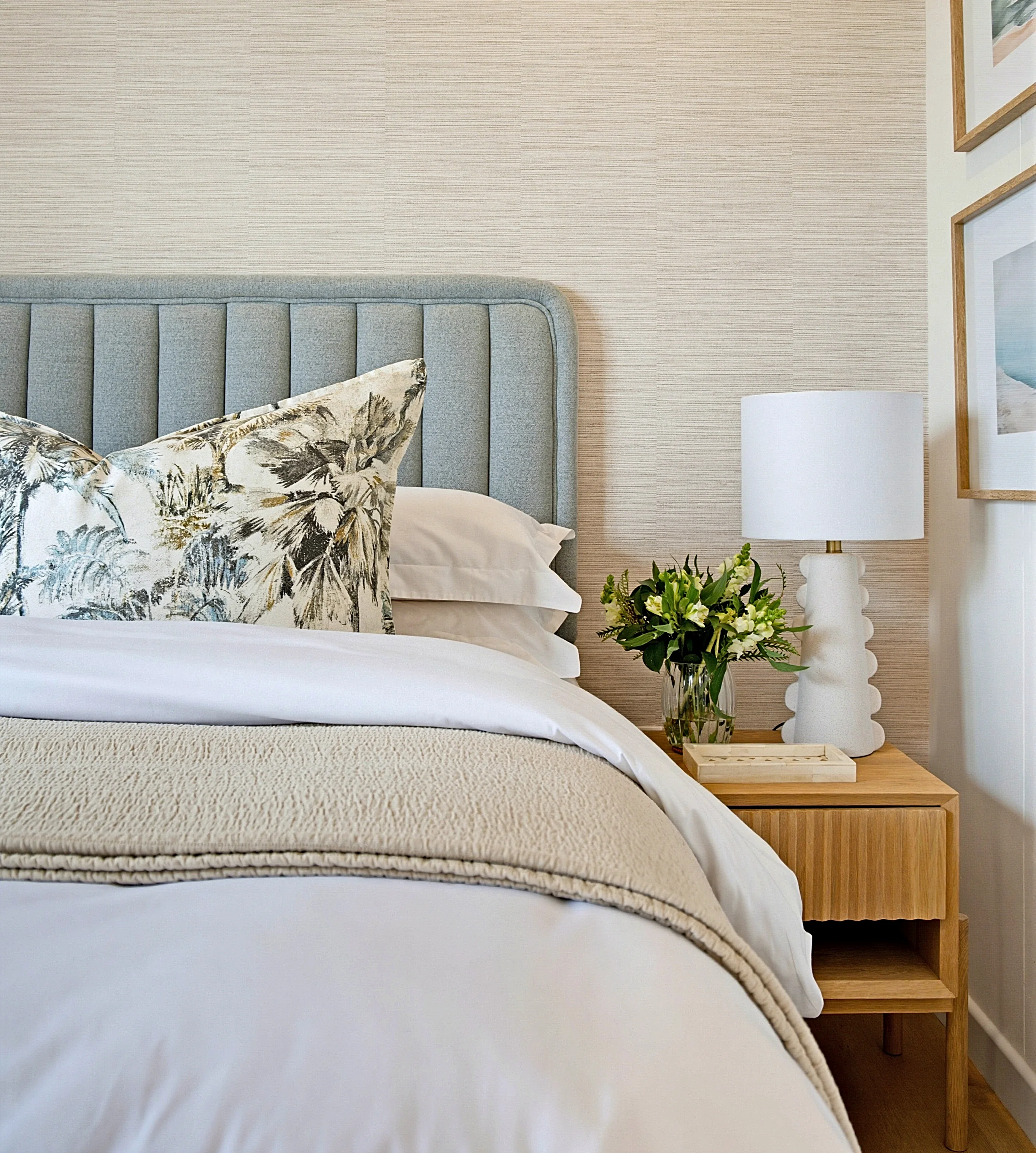 Guest bedroom 1 at Simbithi Eco-Estate: fluted timber bedside table, bobbin lamp and framed coastal prints