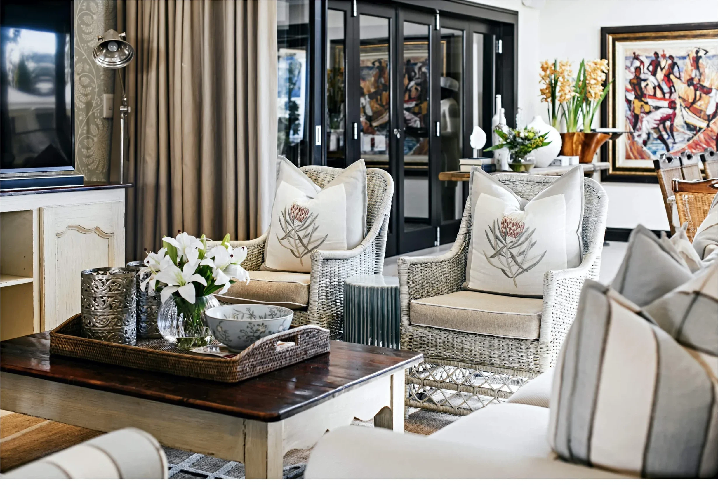 Living room in Johannesburg with light sofas beside glass doors