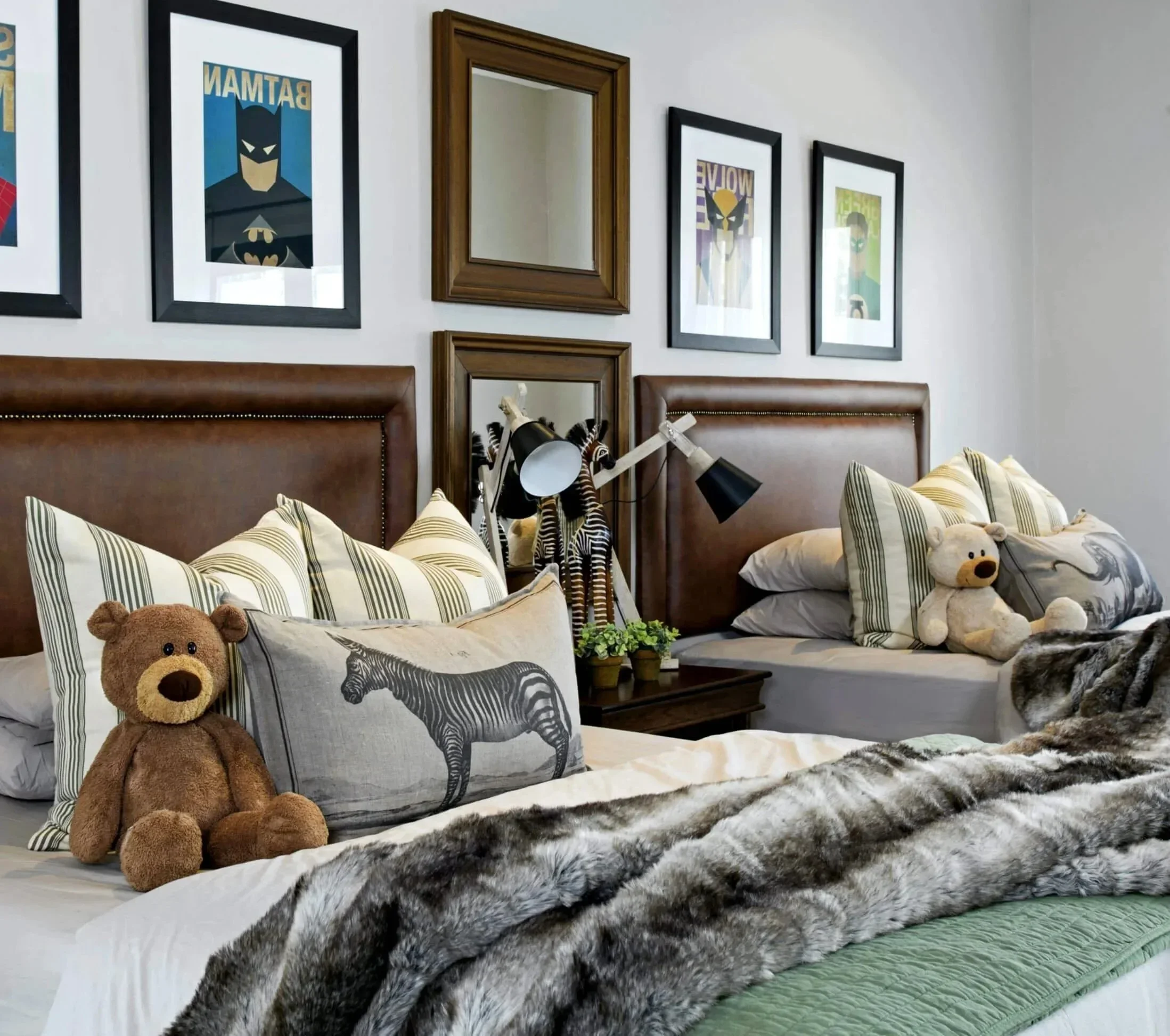 Boys' bedroom with animal print cushions, a faux fur throw, soft toys and framed prints