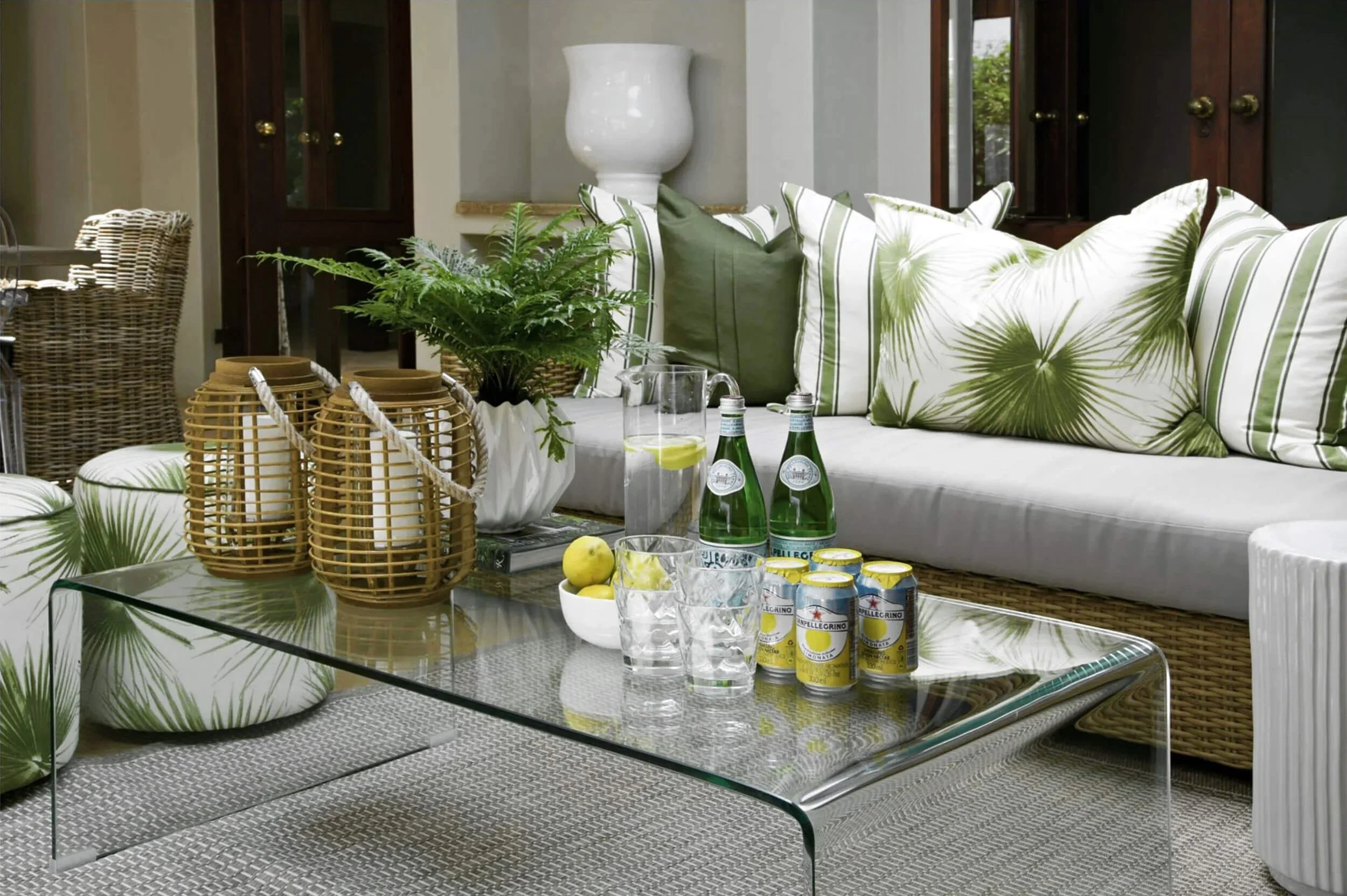 Living room in Johannesburg with a glass table and green cushions